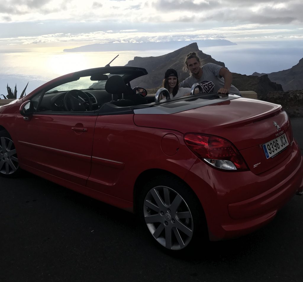 A couple posing in a convertible near La Masqa in Tenerife 